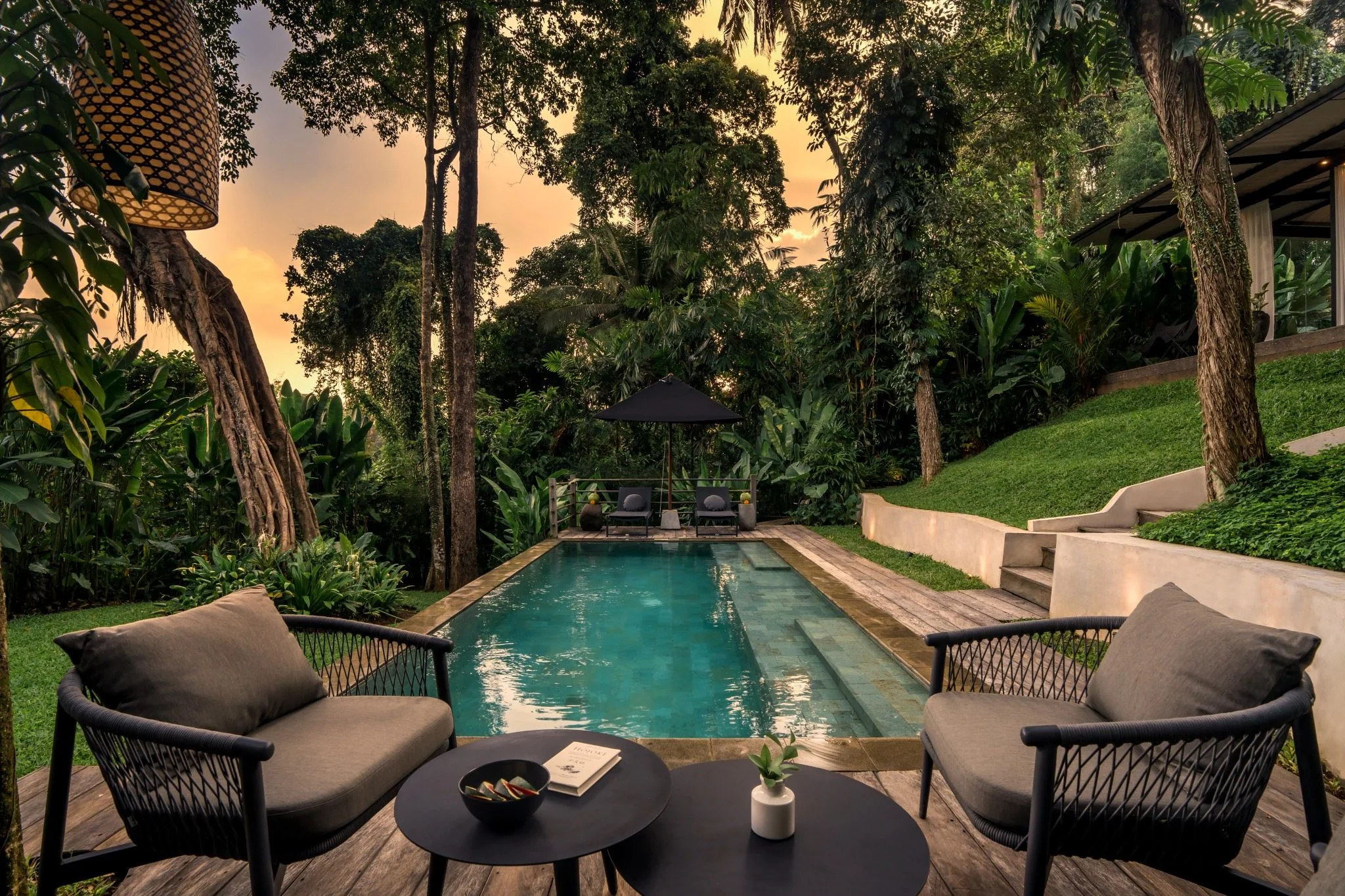 Private pool with lounge seating surrounded by tropical greenery